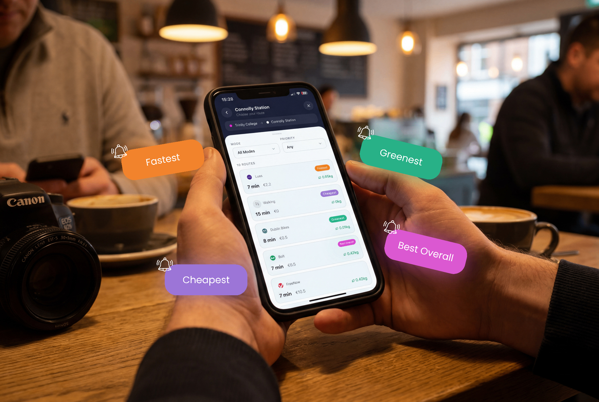 Phone showing fastest, cheapest and greenest route options in a cafe